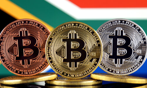 Physical version of Bitcoin (BTC) and South Africa Flag. Concept