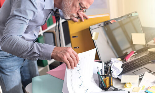 Disorganized businessman looking for documents, light effect